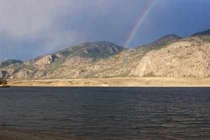Rainbow over the desert hills across Osoyoos Lake